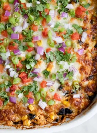 Delicious Chicken Burrito Casserole topped with melted cheese and fresh ingredients
