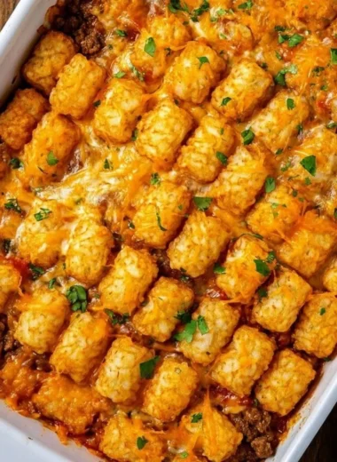 Delicious Cowboy Casserole topped with cheese and jalapeños on a serving plate.