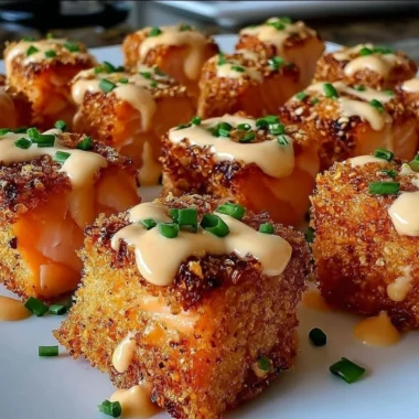 Crispy Bang Bang Salmon Bites served on a plate with dipping sauce.