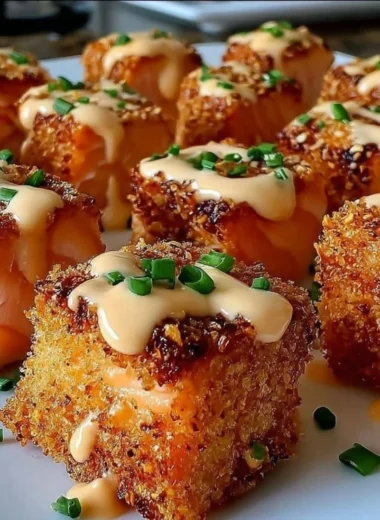 Crispy Bang Bang Salmon Bites served on a plate with dipping sauce.