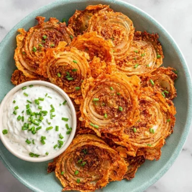 Crispy onion ring chips served in a bowl for a delicious snack.