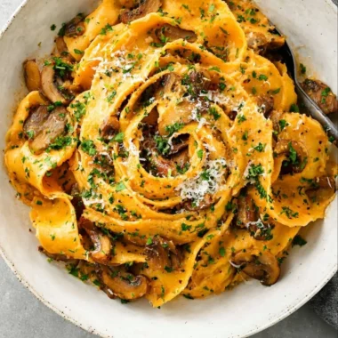 Delicious garlic mushroom pasta served in a bowl with herbs and cheese