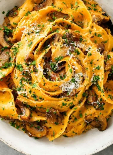 Delicious garlic mushroom pasta served in a bowl with herbs and cheese
