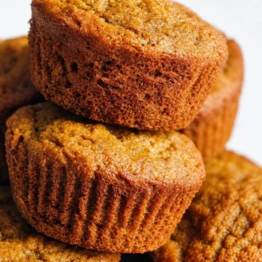 Gluten Free Paleo Pumpkin Protein Muffins in a rustic setting