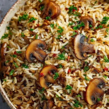 Delicious Mushroom Rice served in a bowl, garnished with herbs