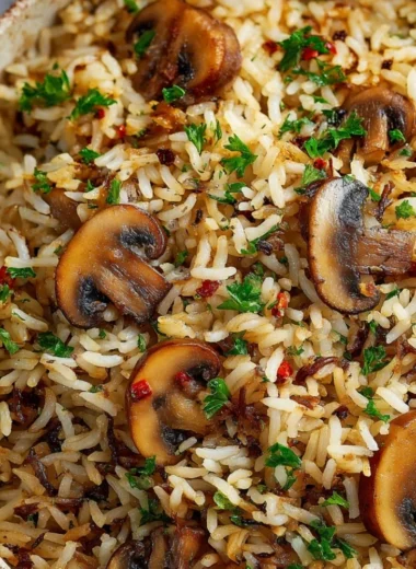 Delicious Mushroom Rice served in a bowl, garnished with herbs
