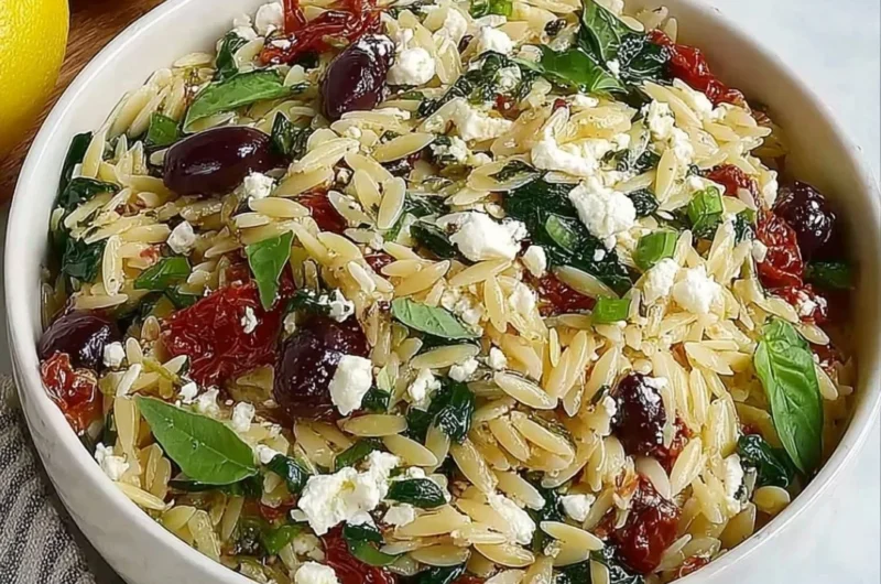 Orzo pasta salad with feta cheese and sun-dried tomatoes in a bowl