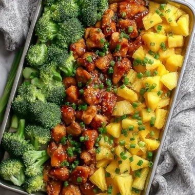 Sweet sheet pan pineapple chicken dish with broccoli on a serving plate