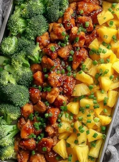 Sweet sheet pan pineapple chicken dish with broccoli on a serving plate