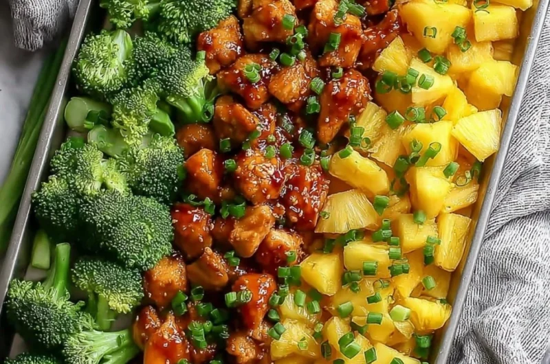 Sweet sheet pan pineapple chicken dish with broccoli on a serving plate