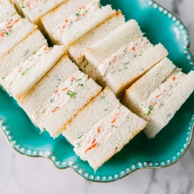 Veggie cream cheese finger sandwiches served on a platter