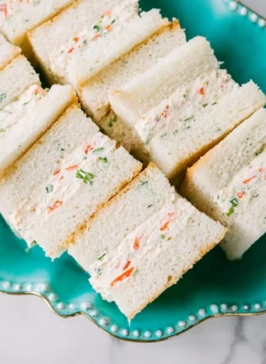 Veggie cream cheese finger sandwiches served on a platter