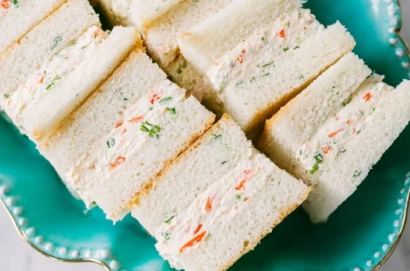Veggie cream cheese finger sandwiches served on a platter