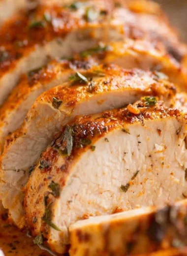 Juicy baked pork tenderloin served with vegetables and herbs