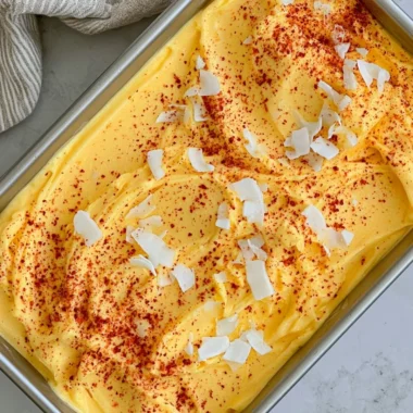 Chili Lime Mango Sorbet in a bowl garnished with lime slices and chili flakes