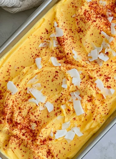 Chili Lime Mango Sorbet in a bowl garnished with lime slices and chili flakes