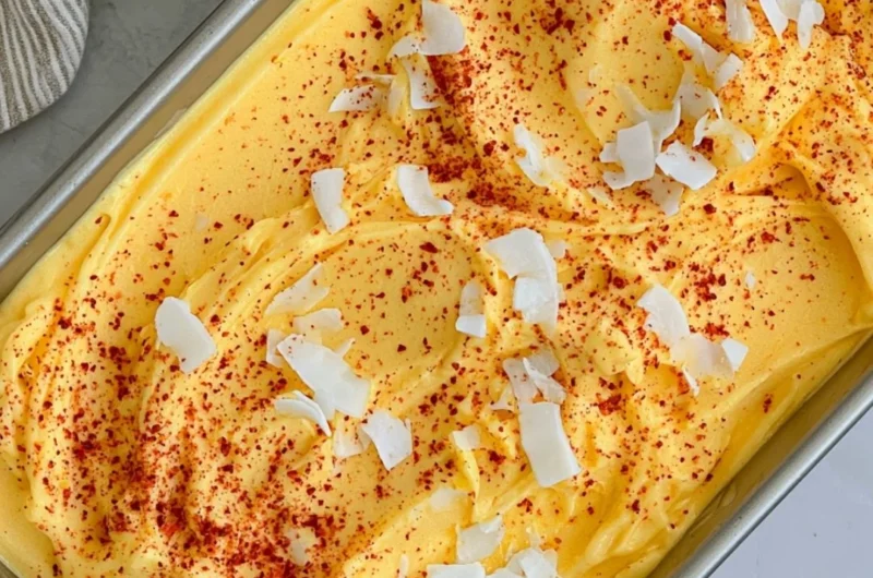 Chili Lime Mango Sorbet in a bowl garnished with lime slices and chili flakes