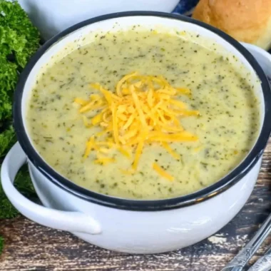 Delicious creamy zucchini soup served in a bowl with fresh garnishes