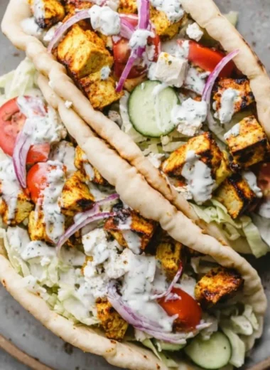 Juicy easy chicken gyros served with fresh veggies and tzatziki sauce.