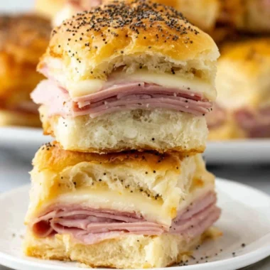 Savory ham and cheese sliders on a platter, ideal for parties and gatherings.