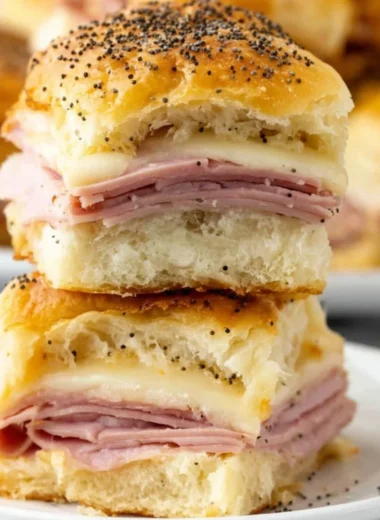 Savory ham and cheese sliders on a platter, ideal for parties and gatherings.