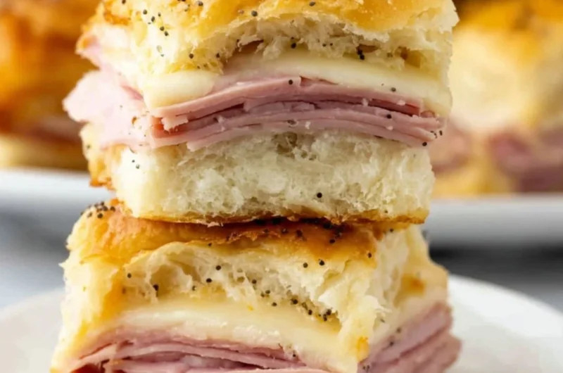 Savory ham and cheese sliders on a platter, ideal for parties and gatherings.