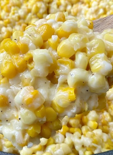 Delicious honey butter skillet corn served in a pan with fresh herbs.
