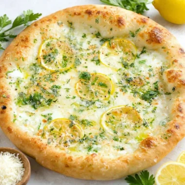 Delicious lemon pizza topped with fresh herbs and cheese