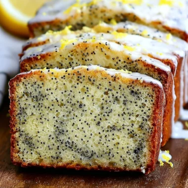 Freshly baked Lemon Poppy Seed Bread with lemon glaze and poppy seeds.