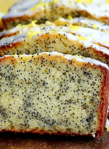 Freshly baked Lemon Poppy Seed Bread with lemon glaze and poppy seeds.