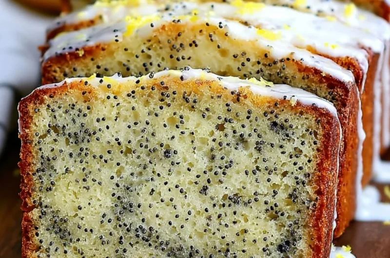 Freshly baked Lemon Poppy Seed Bread with lemon glaze and poppy seeds.
