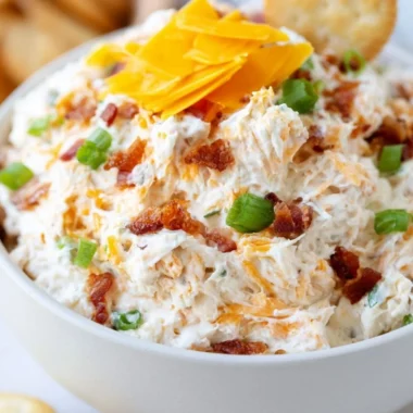Delicious Million Dollar Crack Dip served in a bowl with toppings.