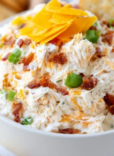 Delicious Million Dollar Crack Dip served in a bowl with toppings.