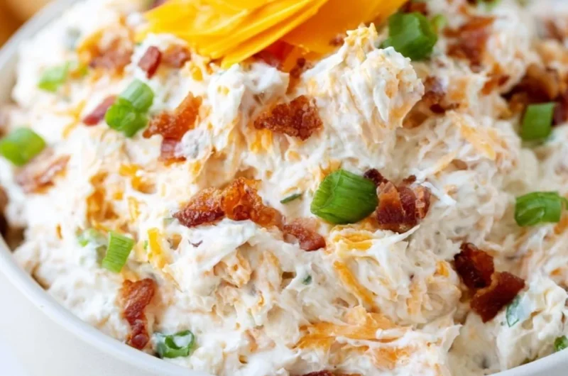 Delicious Million Dollar Crack Dip served in a bowl with toppings.