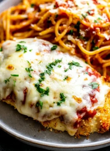 Oven baked chicken parmesan topped with melted cheese and marinara sauce