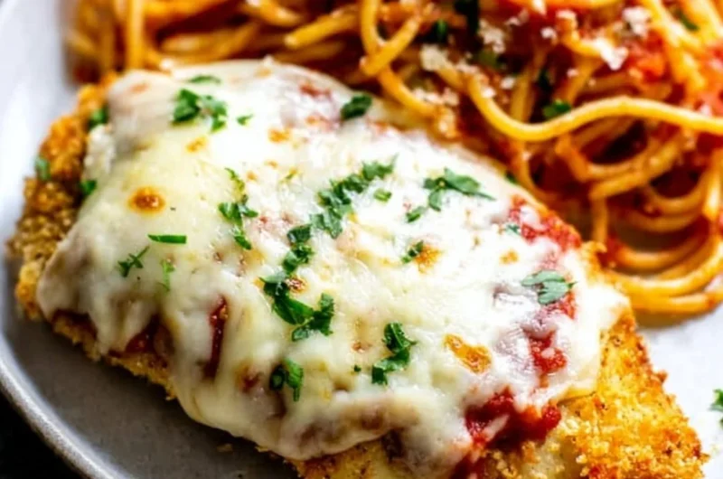 Oven baked chicken parmesan topped with melted cheese and marinara sauce