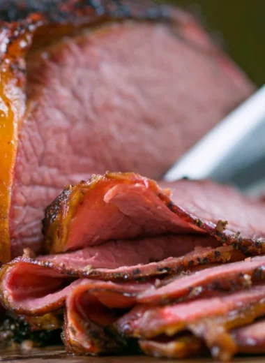 Deliciously smoked roast beef served on a wooden cutting board.