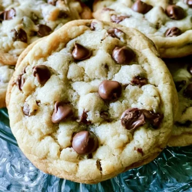 Soft batch chocolate chip cookies with melted chocolate chips on a baking sheet