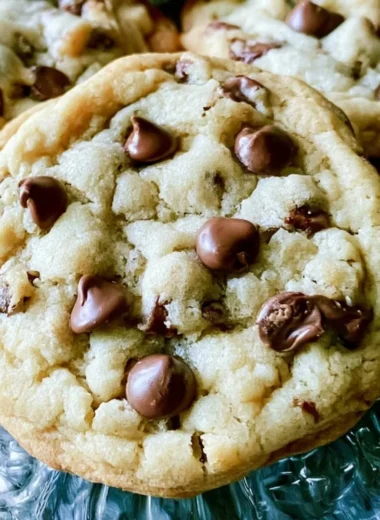 Soft batch chocolate chip cookies with melted chocolate chips on a baking sheet