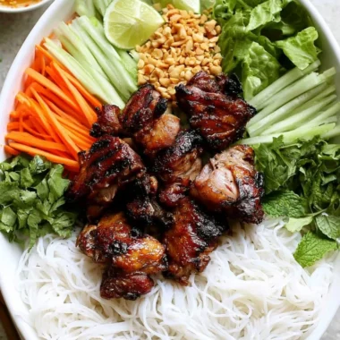 Delicious Vietnamese grilled pork rice noodle bowl garnished with fresh herbs.