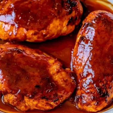 30 minute BBQ baked chicken breasts served on a plate with sides.