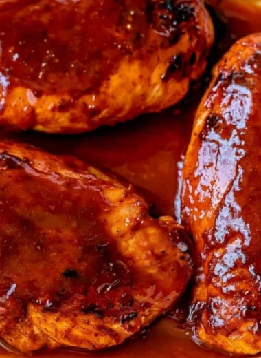 30 minute BBQ baked chicken breasts served on a plate with sides.
