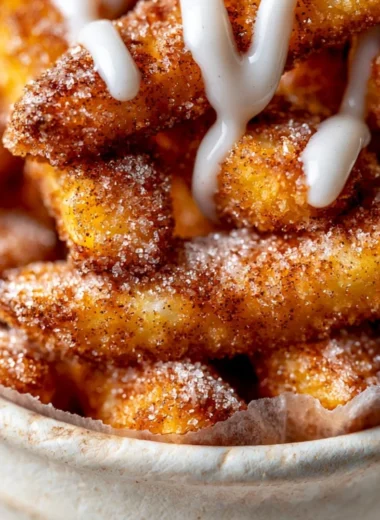 Delicious air fryer apple fries served in a bowl with cinnamon sugar.