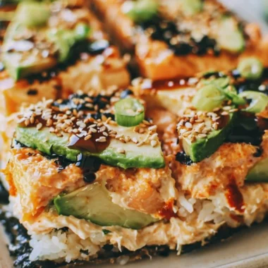 Baked Spicy Salmon Sushi Casserole dish with layer of salmon and rice
