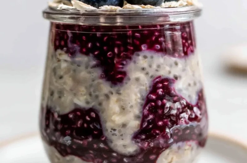 Bowl of blueberry overnight oats topped with fresh blueberries and nuts