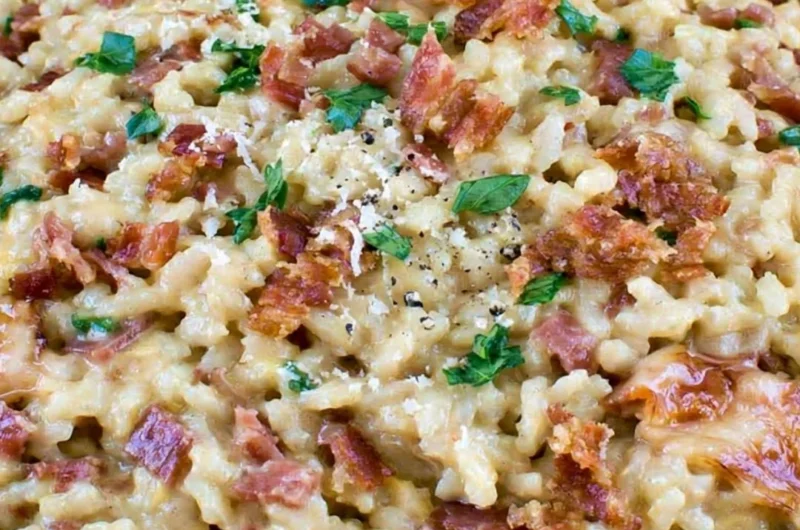 Creamy Carbonara Risotto garnished with bacon and parsley in a plate