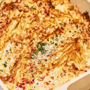 Plate of creamy garlic butter cabbage garnished with herbs