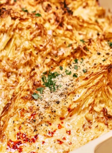 Plate of creamy garlic butter cabbage garnished with herbs