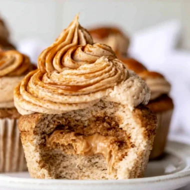 Homemade dulce de leche cupcakes with caramel frosting and toppings.