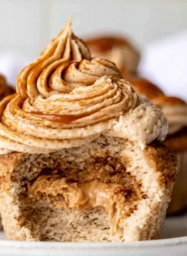 Homemade dulce de leche cupcakes with caramel frosting and toppings.